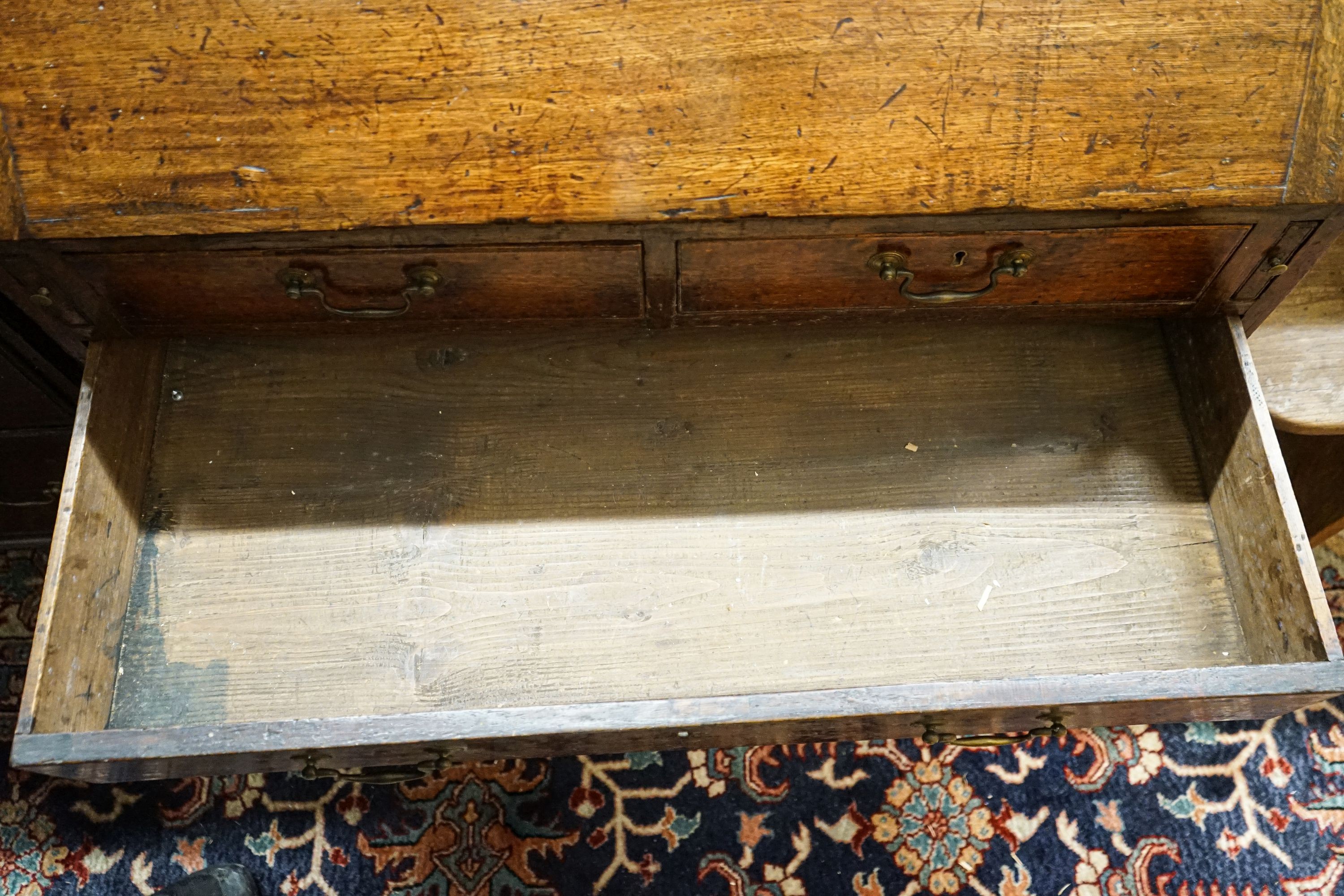A George III oak bureau, with fitted interior, two short and three long drawers, width 92cm, depth 50cm, height 100cm